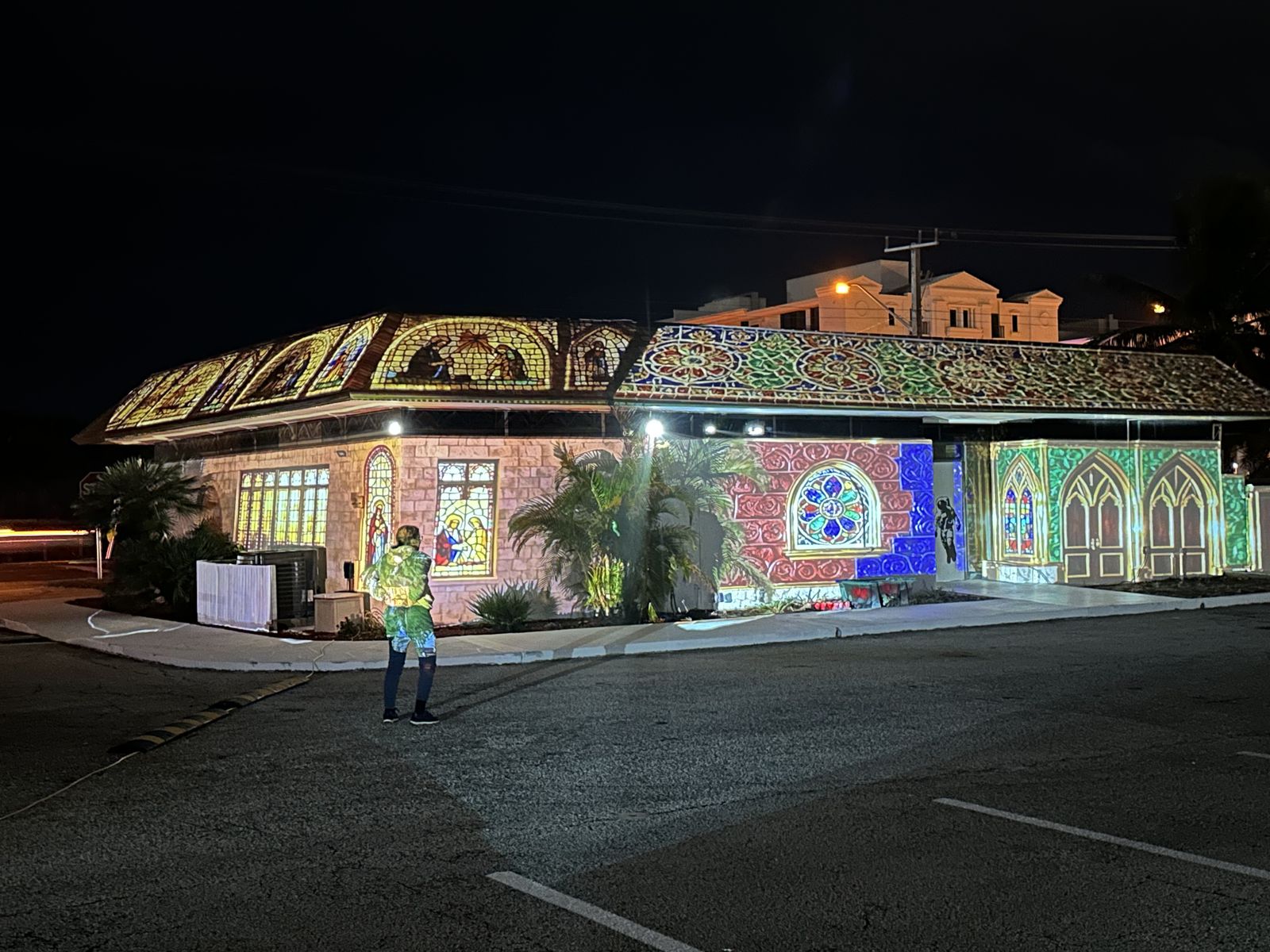 A building covered in projected stained glass at night